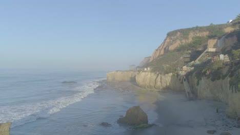 Tomas-Aéreas-De-La-Playa-El-Matador-Sobre-Olas-Y-Rocas-En-Una-Brumosa-Mañana-De-Verano-En-Malibu,-California