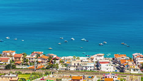 High-angle-shot-of-motor-boats-docked-along-the-shoreline-in-northen-Sicily-coast,-Italy-throughout-the-day-in-timelapse