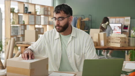 man packing boxes for small business
