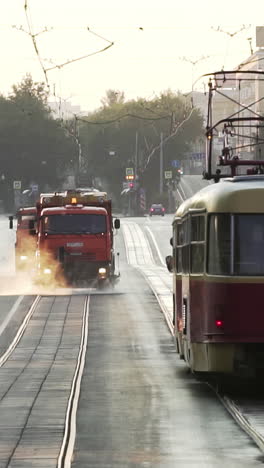 street cleaning and tram in a city