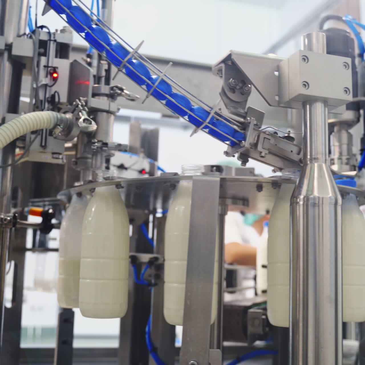 Production line at modernized dairy factory. Automated production line at milk factory. Milk pouring into plastic bottle at dairy plant.