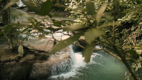 slow motion slider shot of a cascading waterfall in erawan national park, thailand