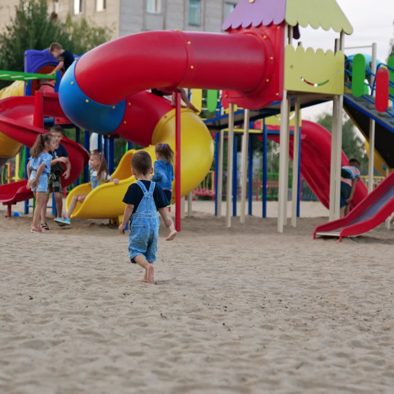 Child on colorful kindergarten. Small boy playing on playground