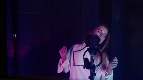 woman singing in recording studio