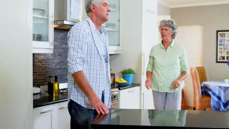 Frustrated-senior-woman-shouting-on-man-in-kitchen-4k