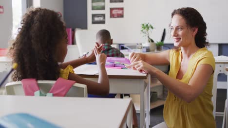 Video-of-happy-caucasian-female-teacher-learning-math-to-african-american-girl