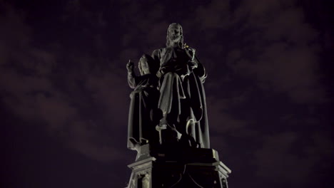 statue of saint joseph with baby jesus against cloudy night sky,prague,czechia