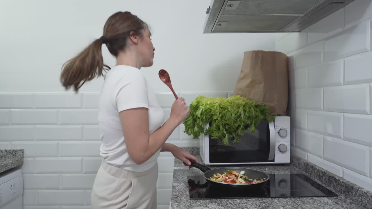 Woman Cooking and Enjoying Stir-Fry