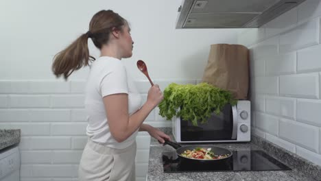 woman cooking and enjoying stir-fry