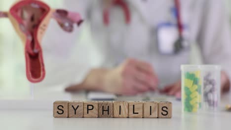 medical setting with 'syphilis' spelled out and doctor in background