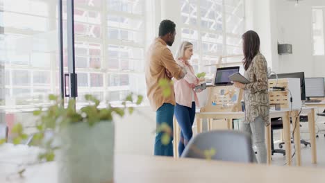 busy diverse business people discussing work with laptop in office in slow motion