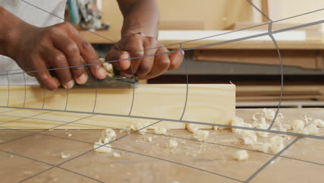 woodworking pro smoothing plank using hand plane, animated shavings swirling around gauge overlays