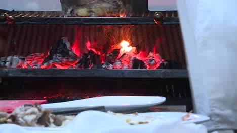 chef cooking steak on charcoal grill