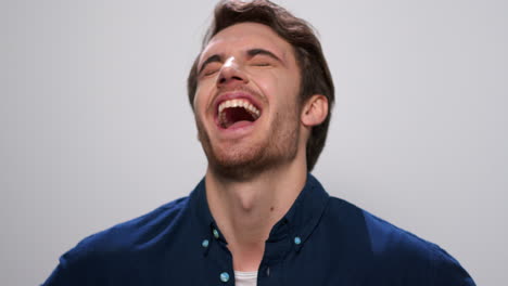 Happy-man-posing-on-white-background.-Guy-laughing-at-camera