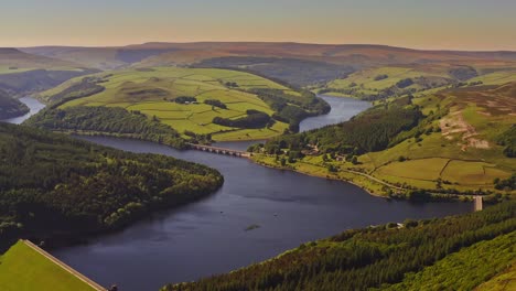 incredible aerial shot over a typical british countryside with hills and rivers