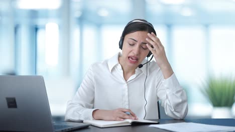 Angry-Indian-call-center-girl-talking-to-customer-and-taking-notes