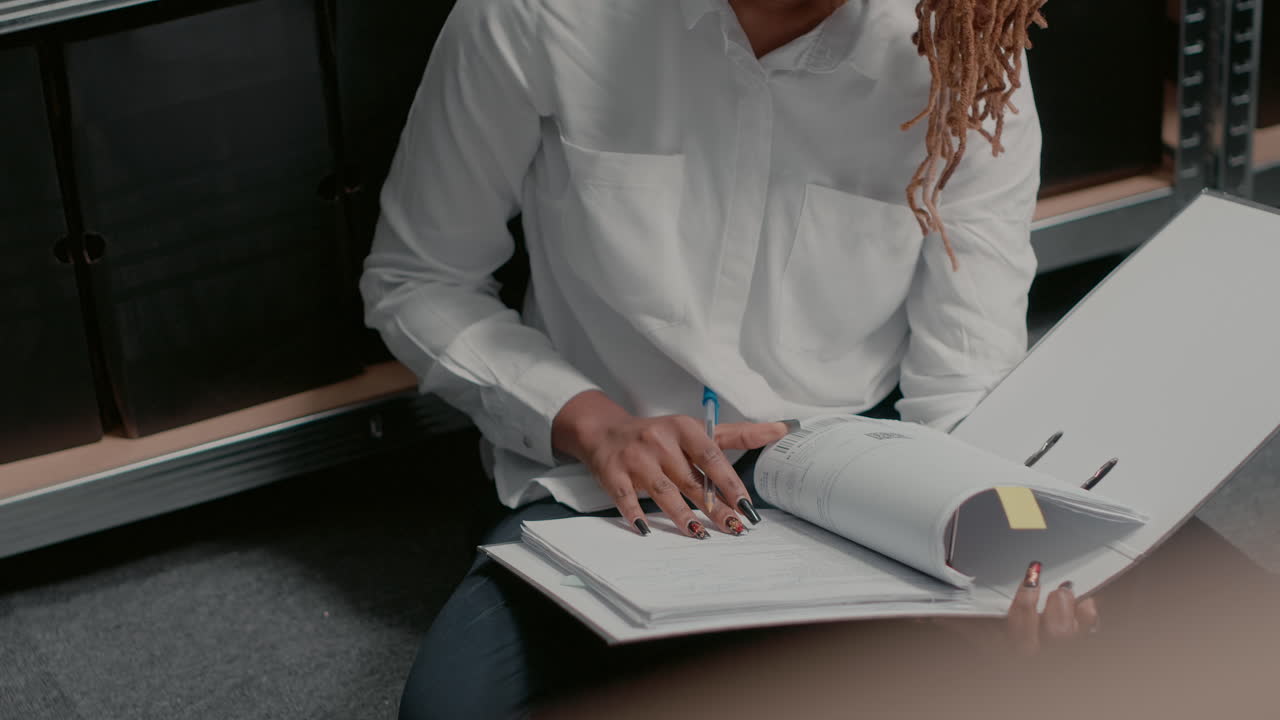Woman reviewing files in office