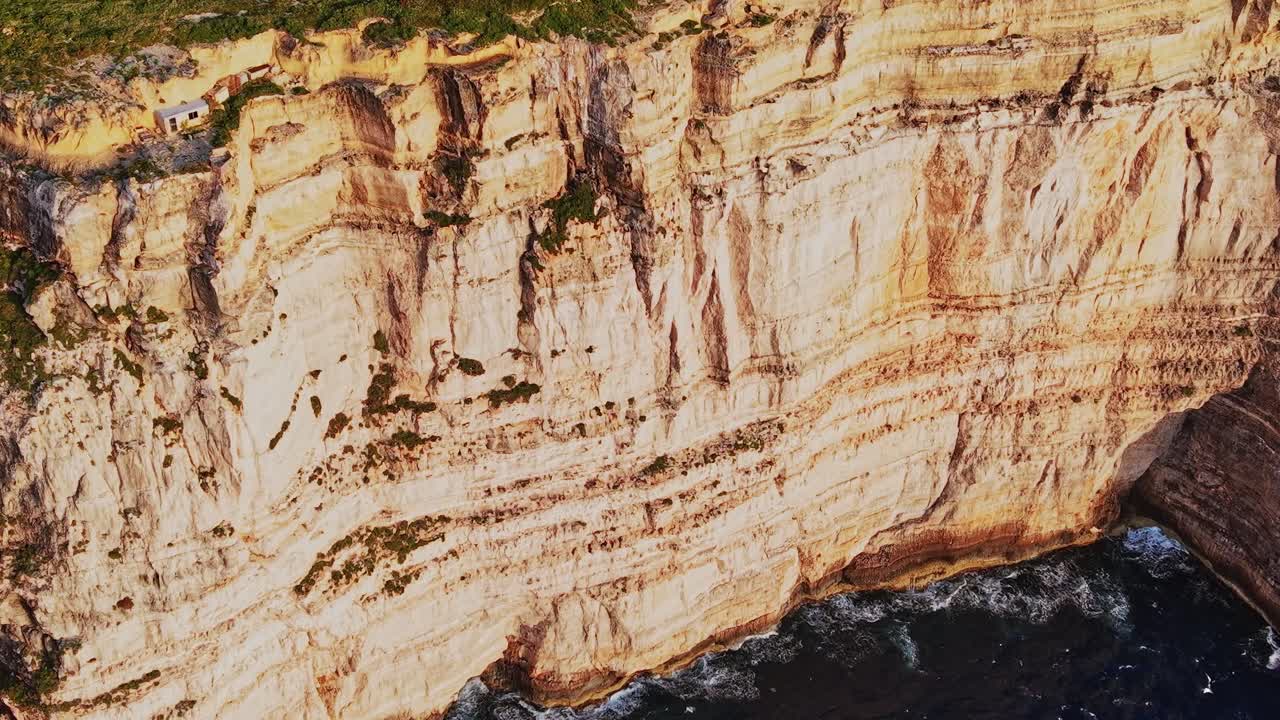 Bright sunlight shines on tall cliffs by the sea
