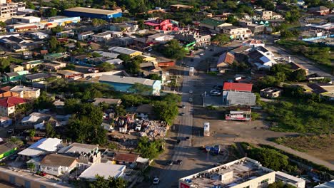 Winding-street-outside-of-main-city-area-in-Willemstad-Curacao,-industrial-zone-as-cars-drive-by