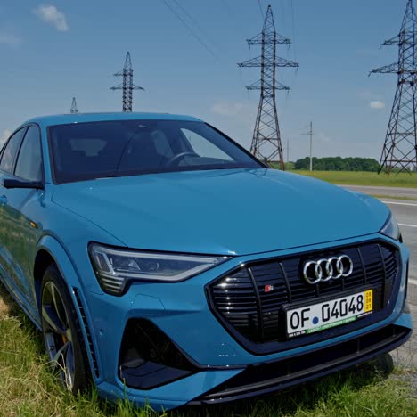 audi e-tron stopped on road. audi e-tron sport 2021 parked on road