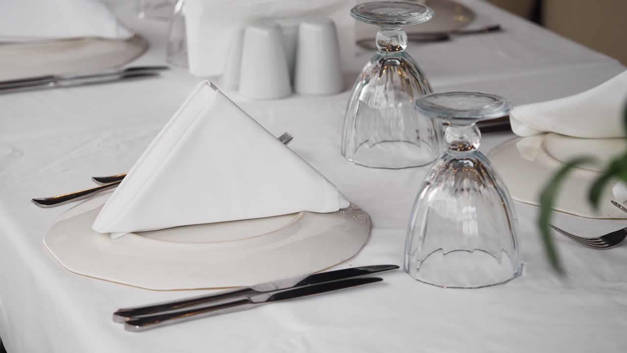 Elegant table setting with white linens and glassware