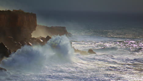 powerful ocean hitting cliffs on stormy day. dramatic waves breaking rocks make