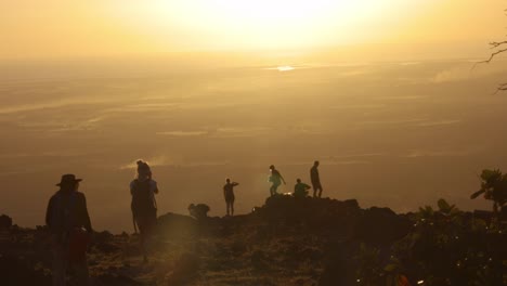 silhouetted hikers witnessing a breathtaking sunset from a mountaintop