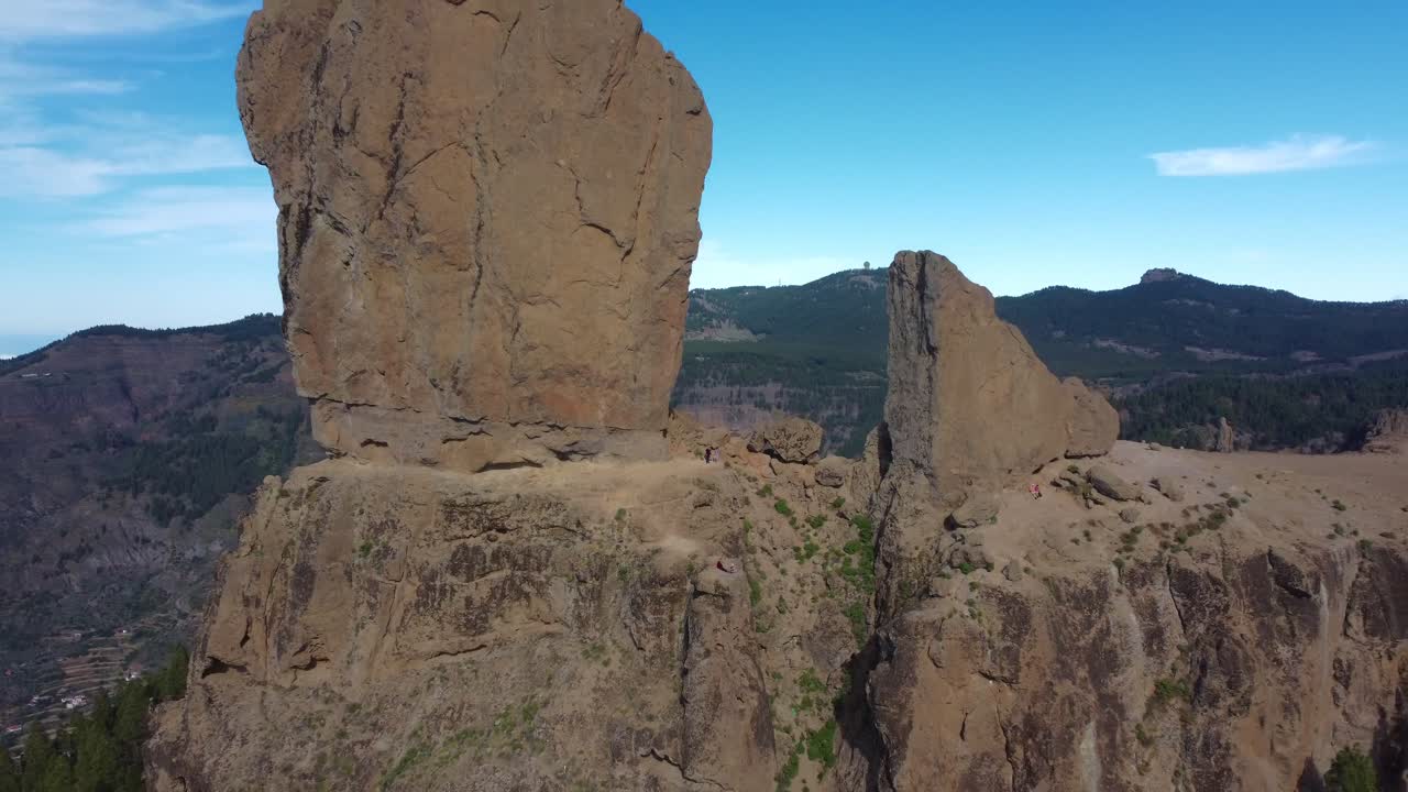 Aerial video of huge 90-metre tall volcanic rock 'Roque Nubile' perched above Gran Canaria, Spain