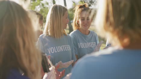 Mid-adults-volunteering-and-clapping-hands-during-river-clean-up-day