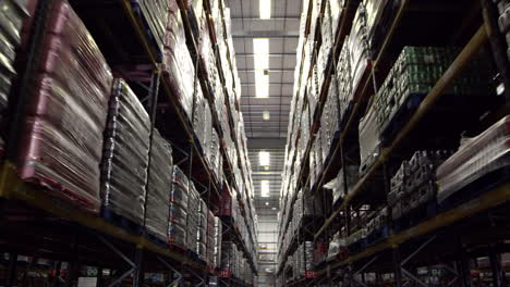 Moving-along-an-aisle-in-a-storage-warehouse,-shot-on-R3D