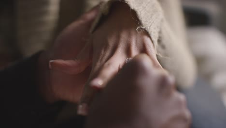 close up of man putting engagement ring on woman's finger as he proposes marriage 2