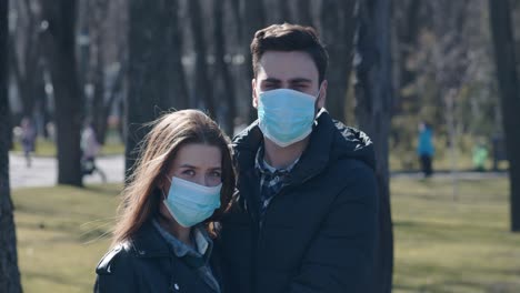 couple wearing masks in a park