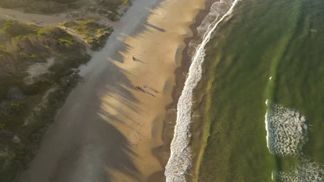 Family-day-in-Playa-Grande-Beach-with-kids-playing-at-sunset,-Uruguay