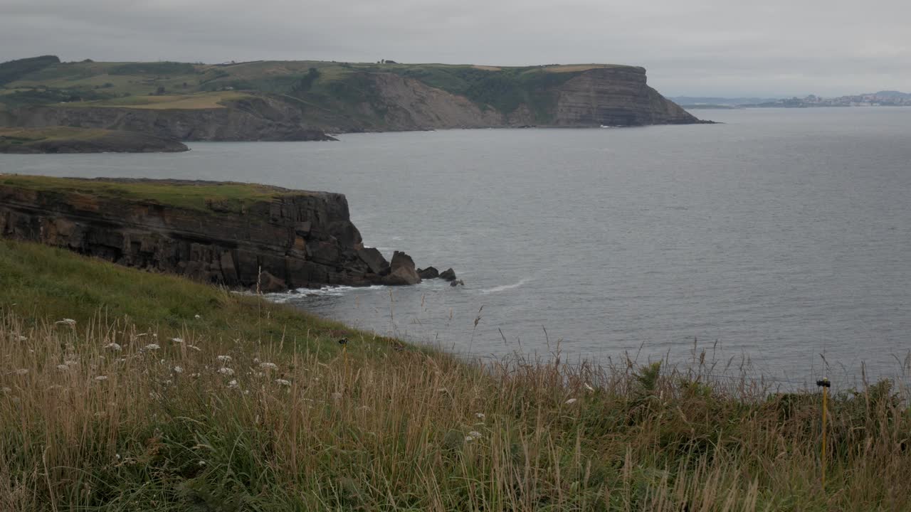 Faro De Ajo, Cantabria Spain coastline with cliffs and ocean view on a cloudy day