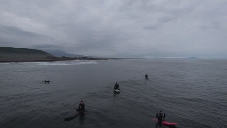 surfing in a volcanic coastal environment