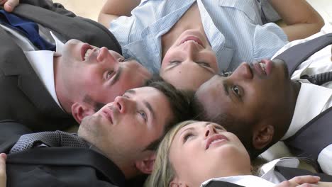 footage of business team relaxing on floor in office