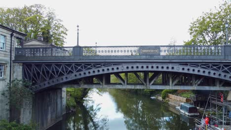 aerial reveal of an iron road bridge undergoing maintenance and surveys