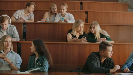 Die-Gruppe-Fröhlicher,-Glücklicher-Studenten,-Die-Vor-Dem-Unterricht-In-Einem-Hörsaal-Sitzen.-Die-Gruppe-Fröhlicher-Studenten,-Die-Vor-Dem-Unterricht-In-Einem-Hörsaal-Sitzen.