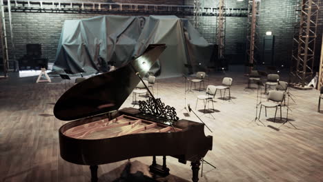 a grand piano on a stage in a concert hall