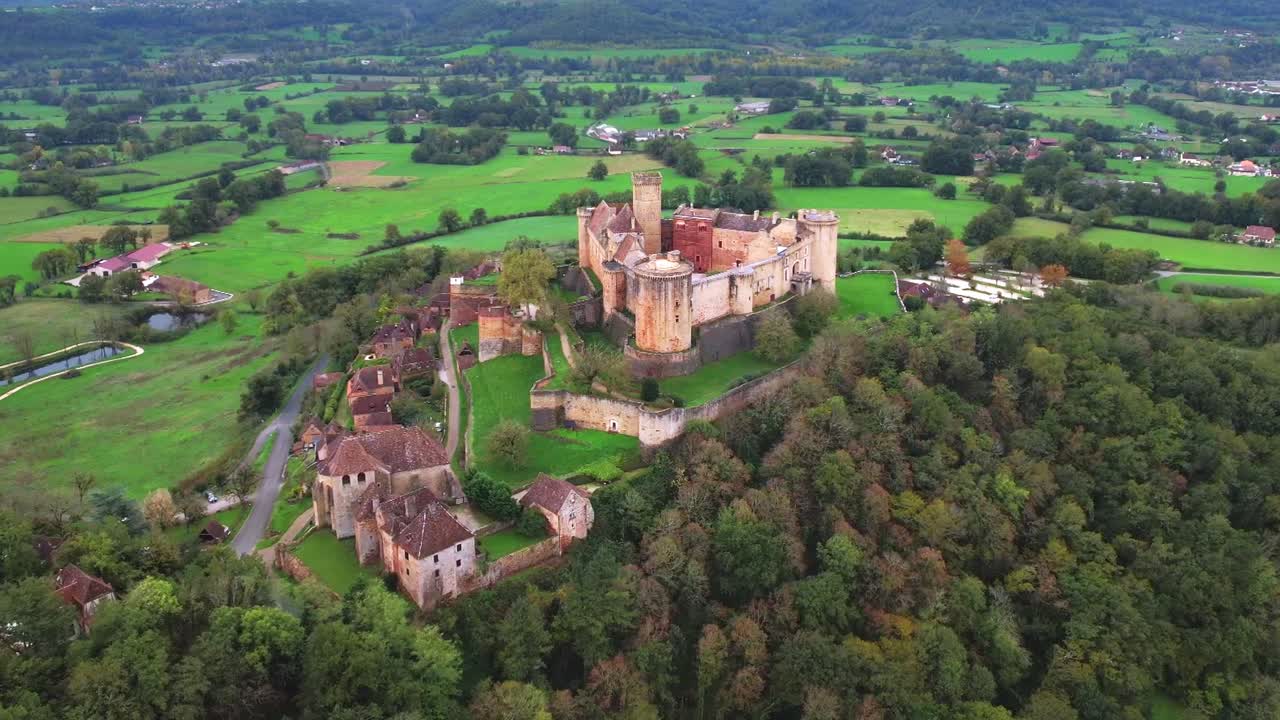 Medieval castle in lush landscape, showcasing ancient defensive structures