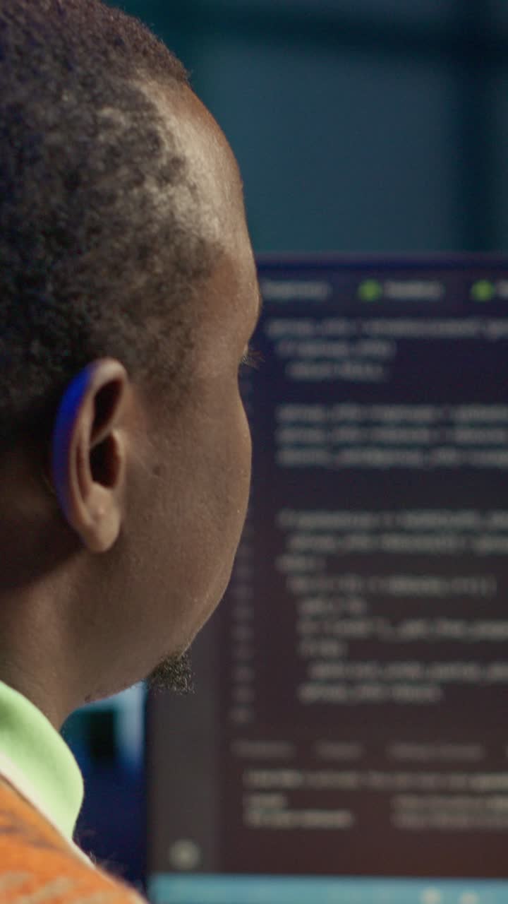Vertical Video African american man working on computer to write code and programming
