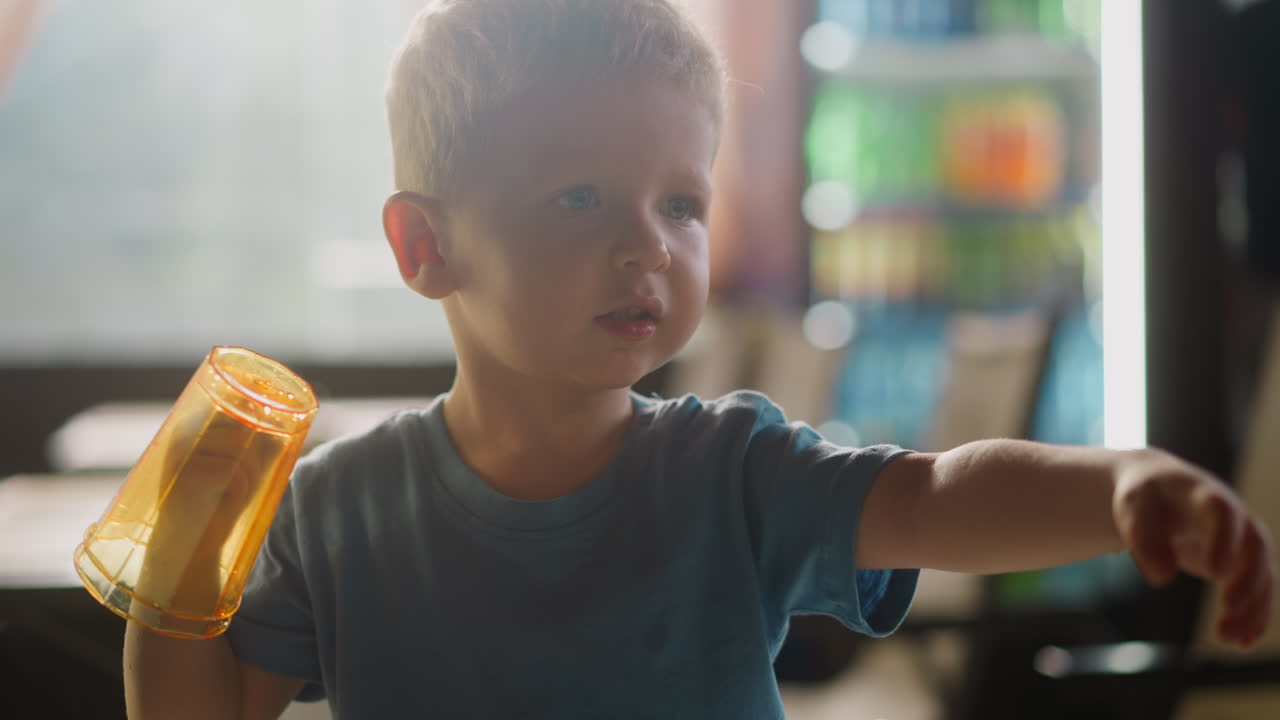 Toddler boy with glasses put on hand talks in restaurant