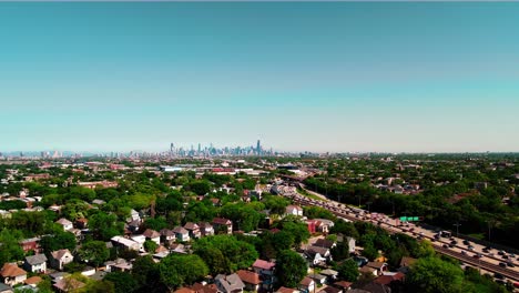 4k slow flight towards interstate above chicago suburbs while having chicago always on view, many trcuks, buses, taxi commuting on interstate i94