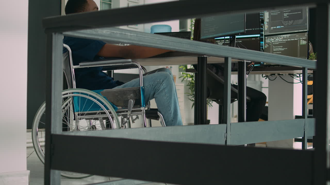 Software app coder in wheelchair writing programming language on computer