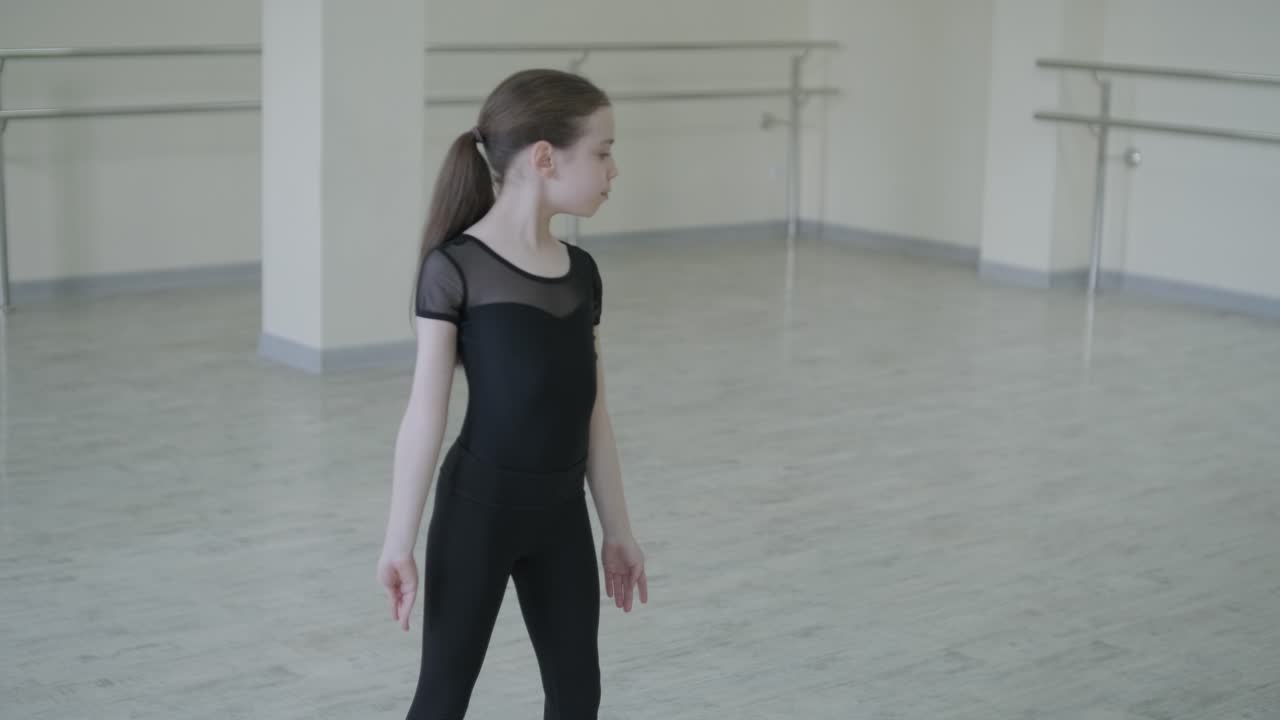 Young Ballerina Practicing Dance Moves in Studio