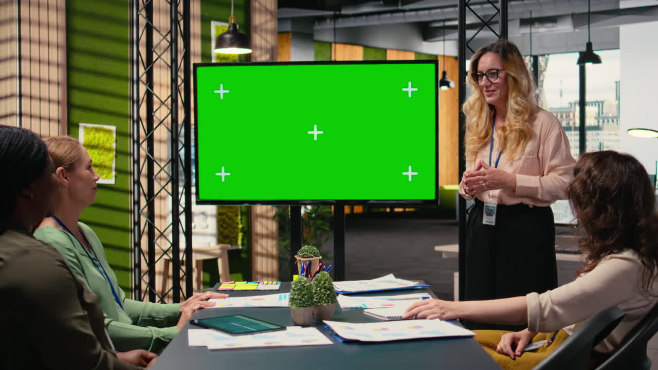 Ambitious business partners aligning strategy in front of a chroma key screen