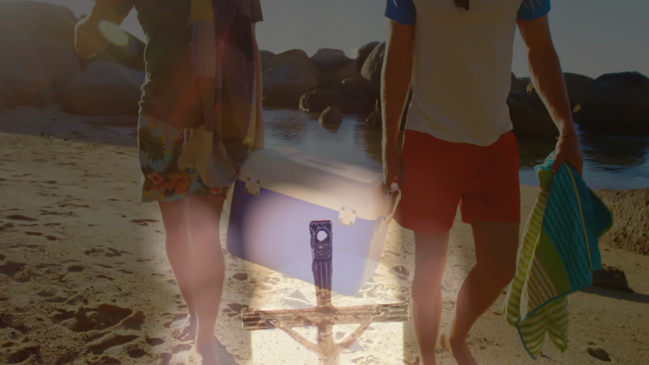 Walking on beach, two people with suitcase and animated overlay