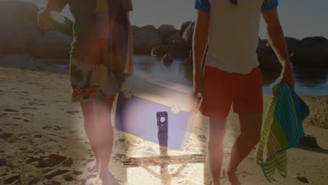 walking on beach, two people with suitcase and animated overlay