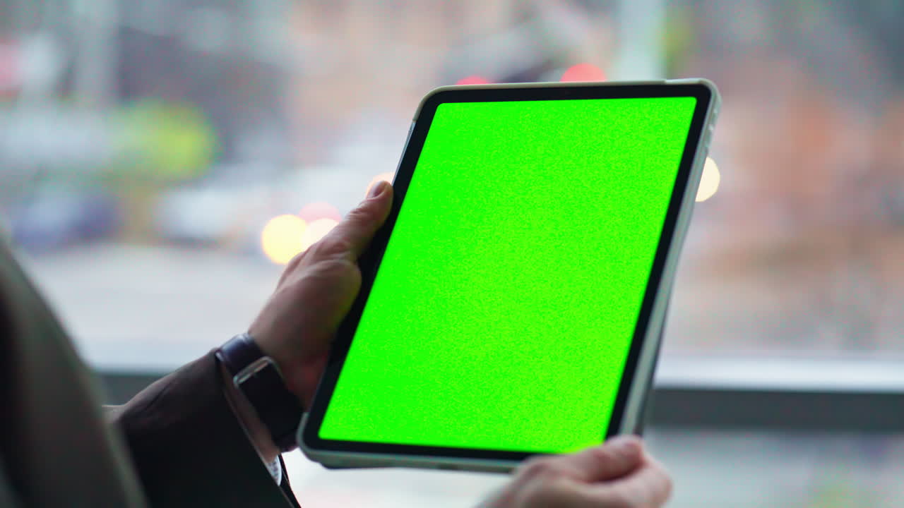 Manager holding mockup tablet by office window closeup. Unknown businessman
