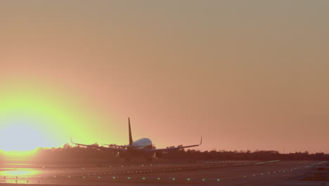 airplane landing at sunset
